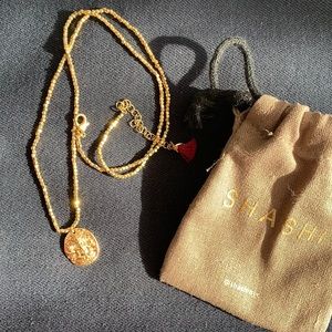 Shashi gold pendent and necklace
